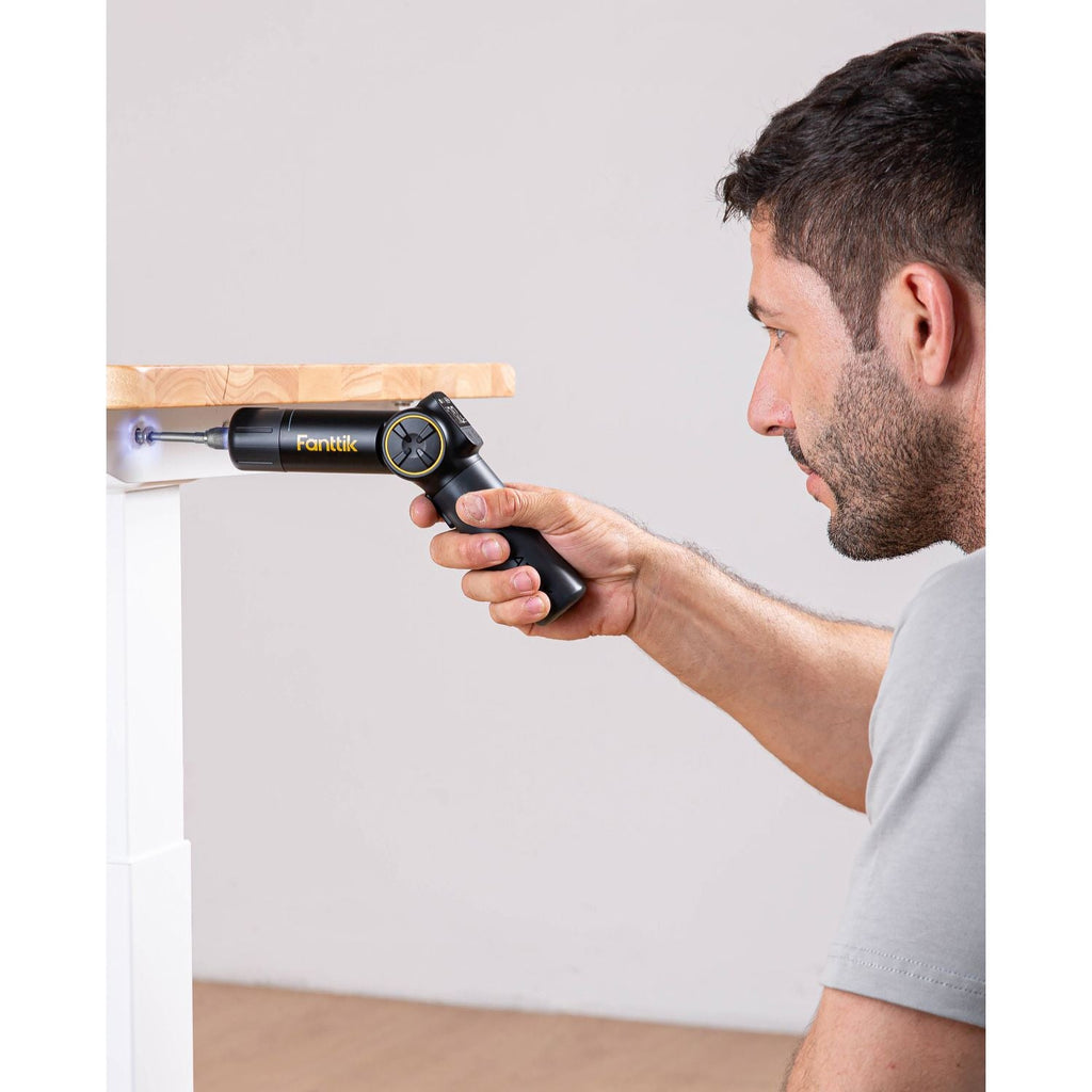 Man using Fanttik Fold S1 APEX cordless screwdriver with LED light for precision screw insertion.